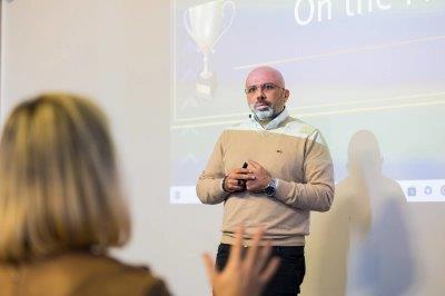 Ahmed presenting in a smaller room with audience participation